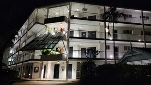 A multi-story hotel with balconies, a staircase, and outdoor plants. - Luxury Haven, Pool, Internet, HDTV, Gym (Palm Cove)