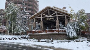 A Westgate building with a stone facade, wooden balcony railings, and a covered entrance area.