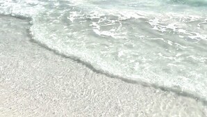 A beach with clear turquoise water and white sand. - True Beachfront!  2 Beachfront Masters - Best Location!! (Anna Maria Island)
