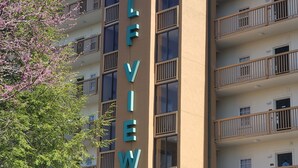 A multi-story building with a prominent sign reading "GOLFVIEW 820". - Mountain Time in Pigeon Forge Close to Dollywood (Pigeon Forge)
