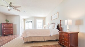 A bedroom with a bed, dresser, nightstand, and a ceiling fan. - 4BR Private Pool Home, Screened Lanai, & 3mi to SRQ Airport (Sarasota)