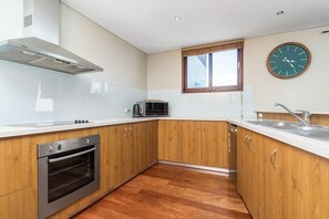 Enjoy cooking in this well-equipped kitchen with a stainless steel oven, microwave, and ample cabinetry.
