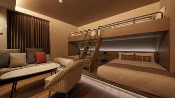 A modern bedroom with a bunk bed, a sofa, a chair, and a desk.