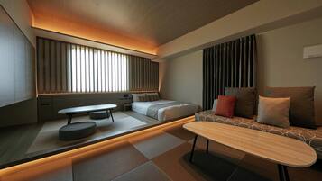 A modern, well-lit room with a sofa, a small table, and a bed.