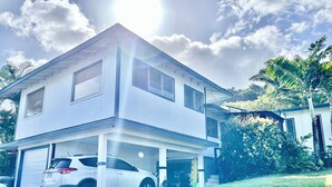 A two-story house with a garage and a covered driveway.
