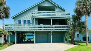 A two-story building with a covered front porch and a garage.