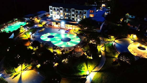 A hotel with multiple swimming pools, a covered area, and a building with multiple floors. - Paradise hotspring hotel (Chenzhou)