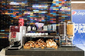 A coffee station with a Nescafe machine, cups, and a variety of coffee beans. - Celine Hotel Taxim (Istanbul)