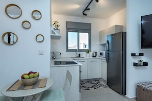 Apartamento, 1 cama Queen e sofá-cama, sacada, vista para a cidade | Cozinha privada | Geladeira grande, fogão, cooktop, máquina de café expresso