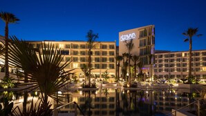 A hotel with a pool, palm trees, and a night sky. - Atzavara Hotel Spa (Santa Susanna)