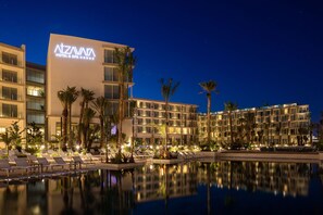 A hotel with a pool, palm trees, and a clear night sky. - Atzavara Hotel Spa (Santa Susanna)