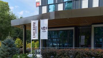 A modern building with two banners for 'Line Brew Reserve' and a 'N' sign above.