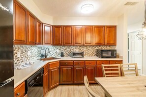 Fridge, dishwasher, coffee/tea maker, cookware/dishes/utensils