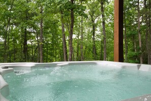 A hot tub surrounded by a forest. - Outdoor Fireplace, S'mores & Mountain Air⎮Game Room⎮Dog Friendly Sleeps 10 (Mineral Bluff)