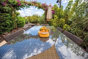 Enjoy a meal in a serene garden setting surrounded by lush greenery and vibrant flowers.