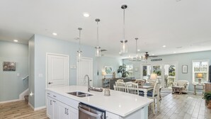 A spacious kitchen with a large island, white cabinetry, and stainless steel appliances. - Beautiful & Beachy!
3BR Townhome Lost Key Golf & Beach Club, Pools, Free Shuttle (Pensacola)