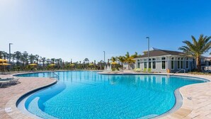 A swimming pool with a curved edge, surrounded by a tiled deck. There are lounge chairs and umbrellas along the poolside. - Beautiful & Beachy!
3BR Townhome Lost Key Golf & Beach Club, Pools, Free Shuttle (Pensacola)