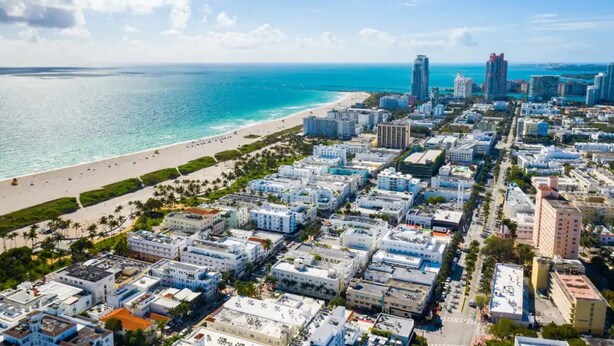 A coastal cityscape with a beach, high-rise buildings, and a clear sky. - Modern South Beach Studio (Miami Beach)