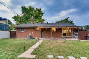 A single-story brick house with a covered porch, a front yard with a pathway, and a garage. - Modern 4BR house near Denver & Boulder (Denver)