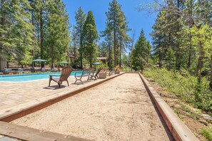 A pool area with lounge chairs, a wooden deck, and a sandy path. - Beautifully updated 3 bedroom townhome in The Northshore complex (Tahoe City)