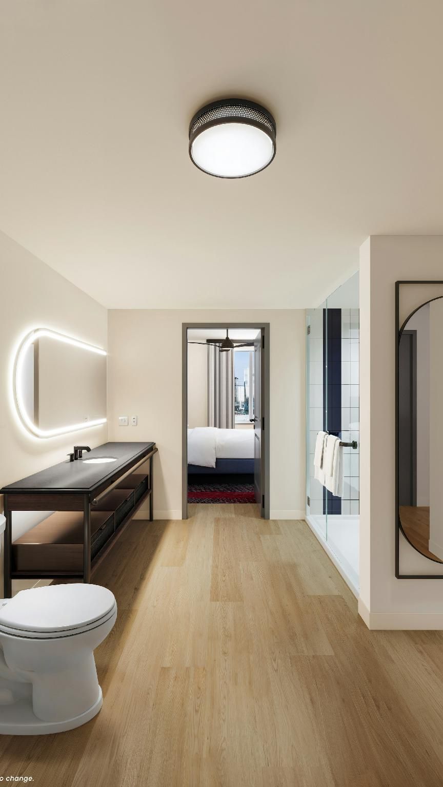 A modern bathroom with a toilet, sink, and mirror.