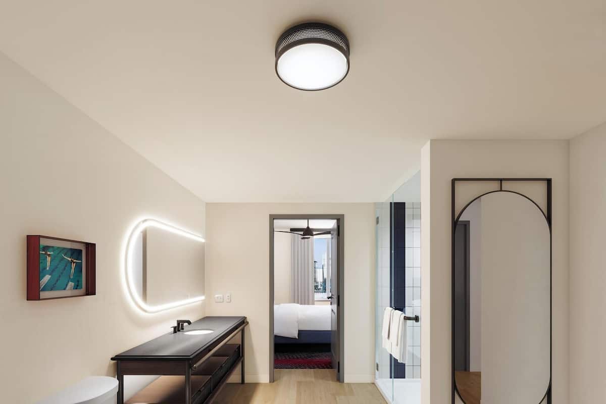 Une salle de bain moderne avec des toilettes, un lavabo et un miroir.