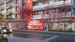 A modern building with a large sign for Sports Illustrated Resorts.