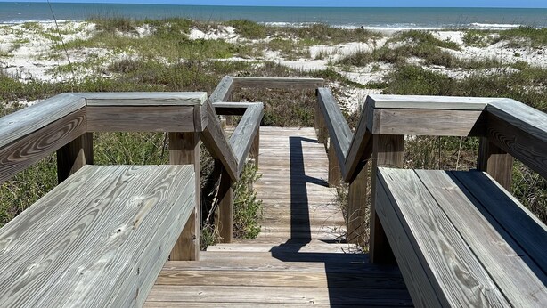 A wooden boardwalk leading to a beach with clear skies. - Direct Oceanfront  South Cocoa Beach. Watch launches from Balcony. (Cocoa Beach)