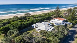 A coastal property with a large house, solar panels, and a view of the ocean. - Birdsong - Central location (Wooli)