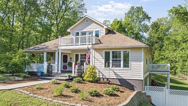 A two-story house with a front porch, a small garden, and a white picket fence. - 3+ acre Home: Pool Table, Putt-Putt, 4 miles to Downtown and SEMO, Summer Pool (Cape Girardeau)