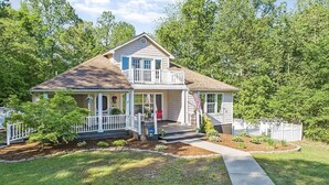 A two-story house with a front porch, a small deck, and a front yard. - 3+ acre Home: Pool Table, Putt-Putt, 4 miles to Downtown and SEMO, Summer Pool (Cape Girardeau)