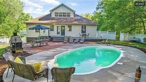 A house with a backyard swimming pool, outdoor furniture, and a barbecue grill. - 3+ acre Home: Pool Table, Putt-Putt, 4 miles to Downtown and SEMO, Summer Pool (Cape Girardeau)