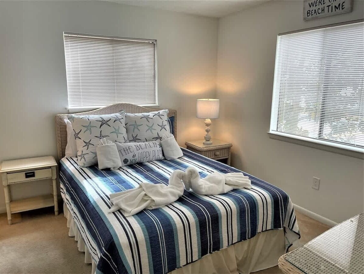 A serene coastal sanctuary featuring a queen-sized bed.