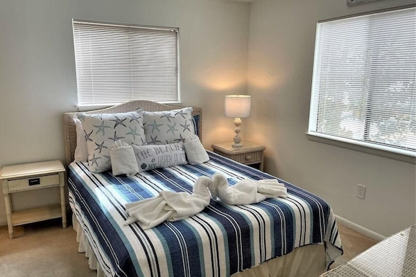 A serene coastal sanctuary featuring a queen-sized bed.