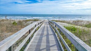 A wooden boardwalk leading to the beach with ocean views. - Amazing Ocean Views From Your Newly Renovated Oceanfront Condo in Carolina Beach (Carolina Beach)