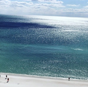 Guests can enjoy a tranquil beach experience with calm waters and a wide, open shore.