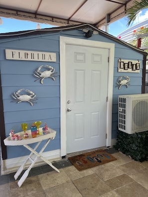 A blue building with a white door, labeled "FLORIDA" and "RELAX".