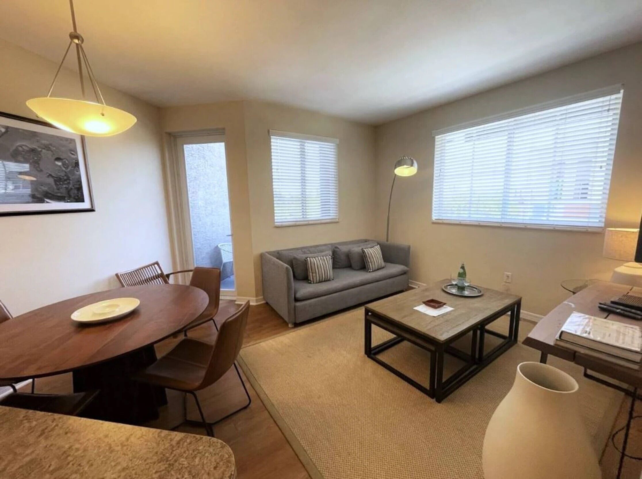 A modern living room with a dining table, sofa, and coffee table.