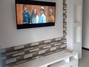 Relax in this stylish living room with a flat-screen TV and entertainment unit.