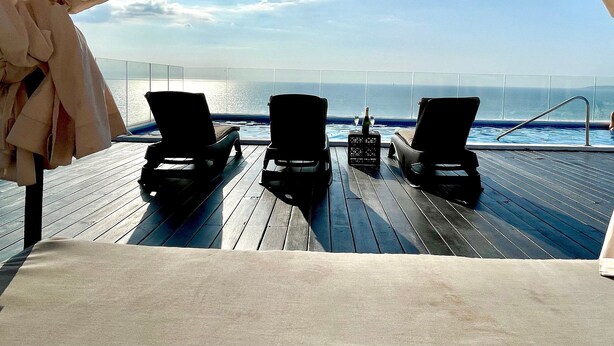 An outdoor deck with lounge chairs and a pool, overlooking the ocean. - BEACHFRONT PENTHOUSE with PRIVATE POOL (Nuevo Vallarta)