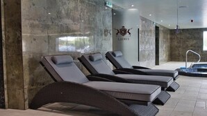 A spa area with reclining chairs and a small pool.