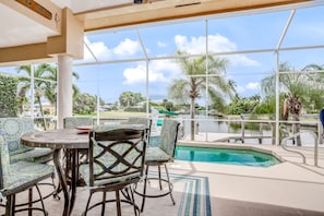 Relax by the pool with a clear view of the surrounding landscape, featuring a rectangular pool with a tiled edge and metal railing.