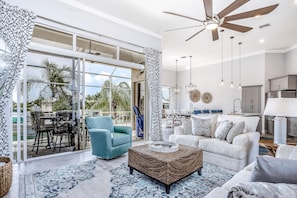 Enjoy a view of palm trees and a clear sky from the spacious balcony with a glass door.