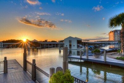 Waterfront condo with furnished balcony, central AC, & washer/dryer