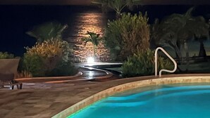 A pool area with a view of the ocean and a cloudy sky. - Tranquil Oceanside: Pools & Direct Beach Access (Sint Maarten)