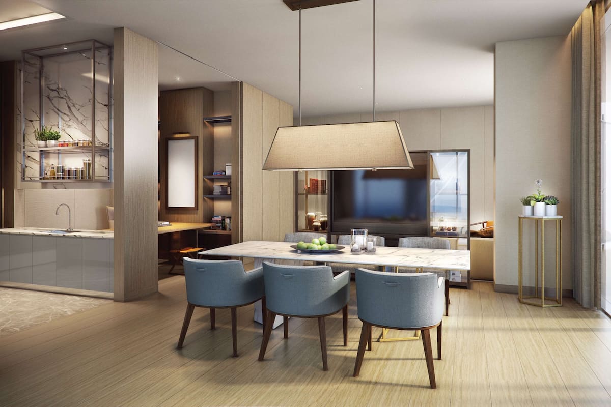A modern kitchen with a central island, built-in shelving, and a large dining area with chairs and a table.