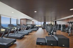 A gym with treadmills, weight machines, and benches.