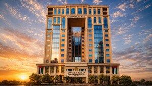 A multi-story hotel with a prominent entrance, large windows, and a sign indicating it's the Khalidia Palace Hotel. - Khalidia Palace Hotel Dubai (Dubai)