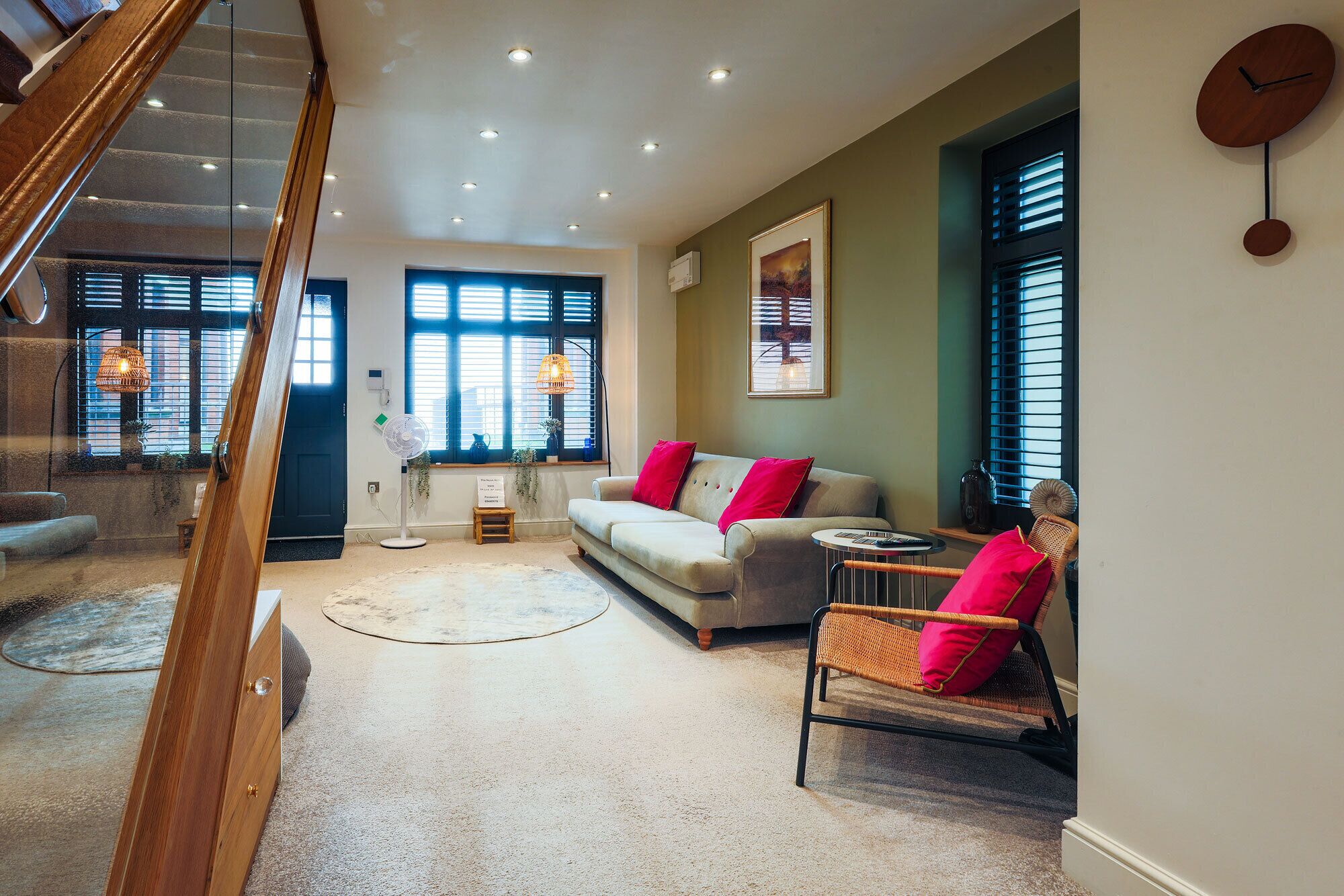 A modern living room with a sofa, a chair, a small table, and a floor lamp.