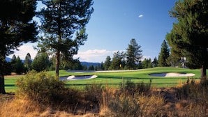 A golf course with sand bunkers, trees, and a clear sky. - PNW Luxe Lodge- 4 Suites, Game Rm, Loft, 12xSHARC, Bikes, Hot Tub, Big Deck, ADA (Sunriver)